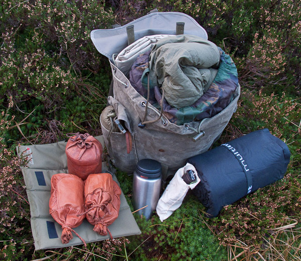 Mountain Pack-Tarp, sleeping bag, Air mat, pegs and guys, water bottle, sit mat, poncho, hobo stove and dried rations. -  2017 - Gary Waidson - Ravenlore