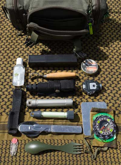 Grab bag. The front pocket contents. -   Gary Waidson - Ravenlore Bushcraft and Wilderness skills.